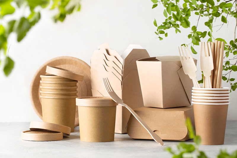 Eco friendly food containers from paper on light table. Plastic free. Top view. Space for text.